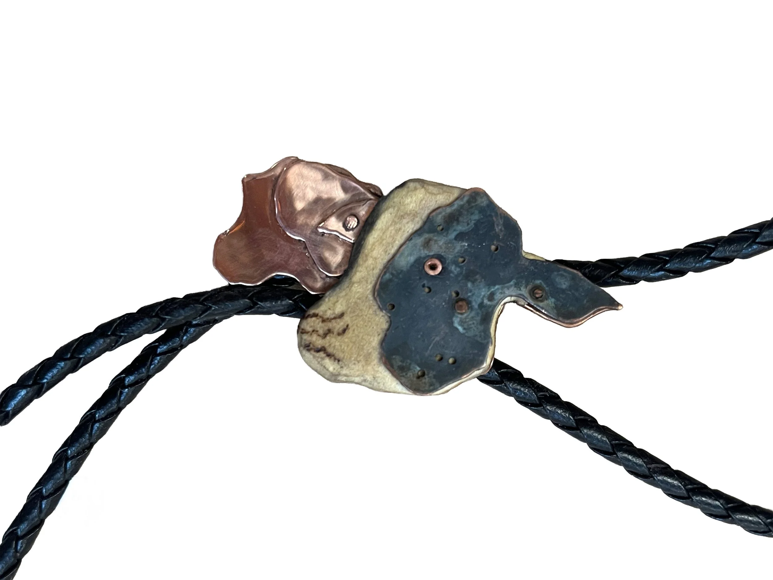 "1000 more years". Bolo tie. 2024. Wood, leather cord, copper, and liver of sulfur patina