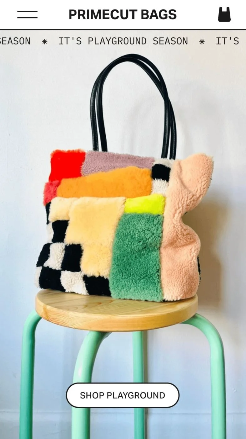Colorful fuzzy tote bag with patchwork design, black handles, on a green-legged wooden stool, against a white background with text promoting Primecut Bags Playground season.