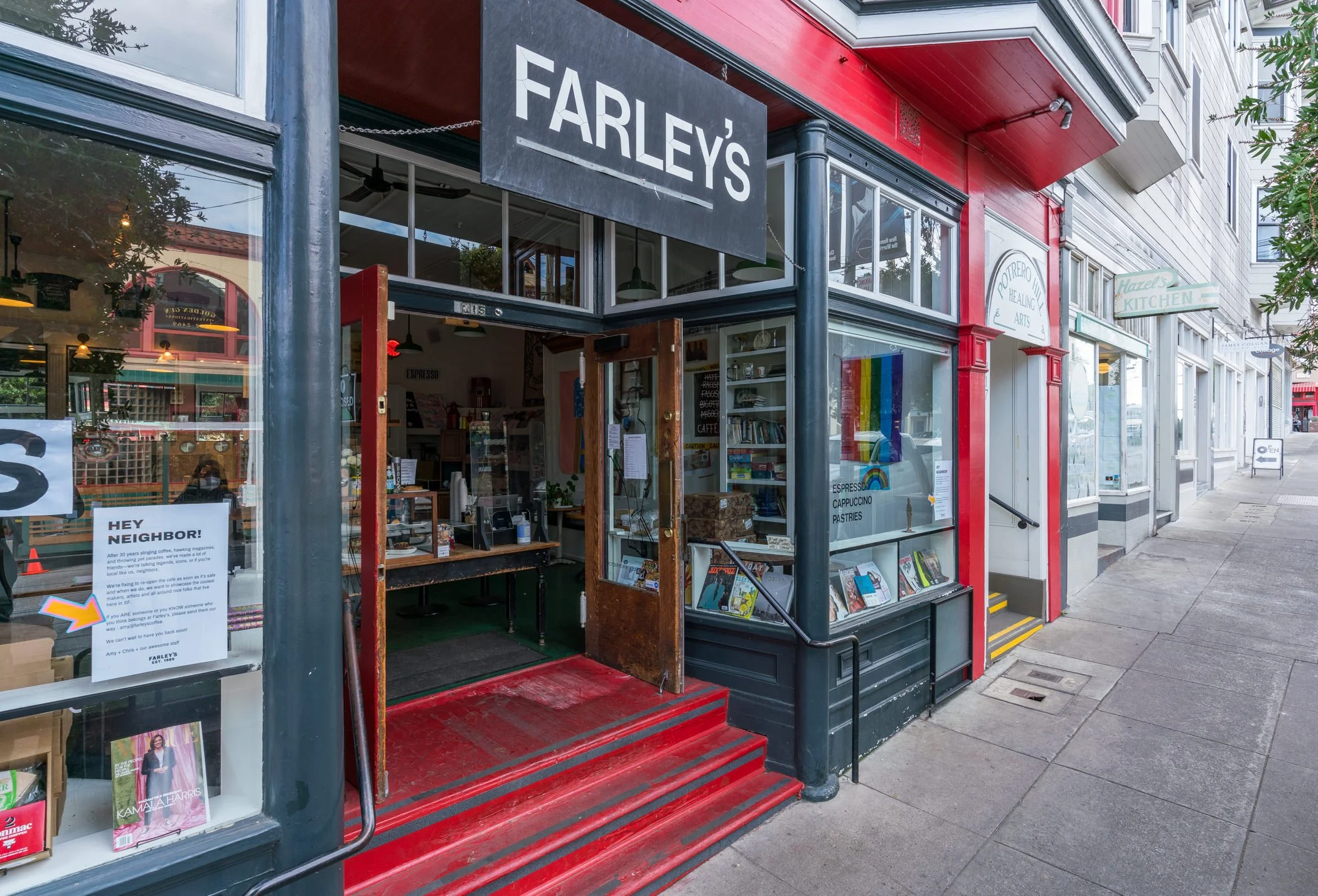 Street view of Farley's café and bookstore with red steps leading to entrance, large glass windows, and neighboring shops.