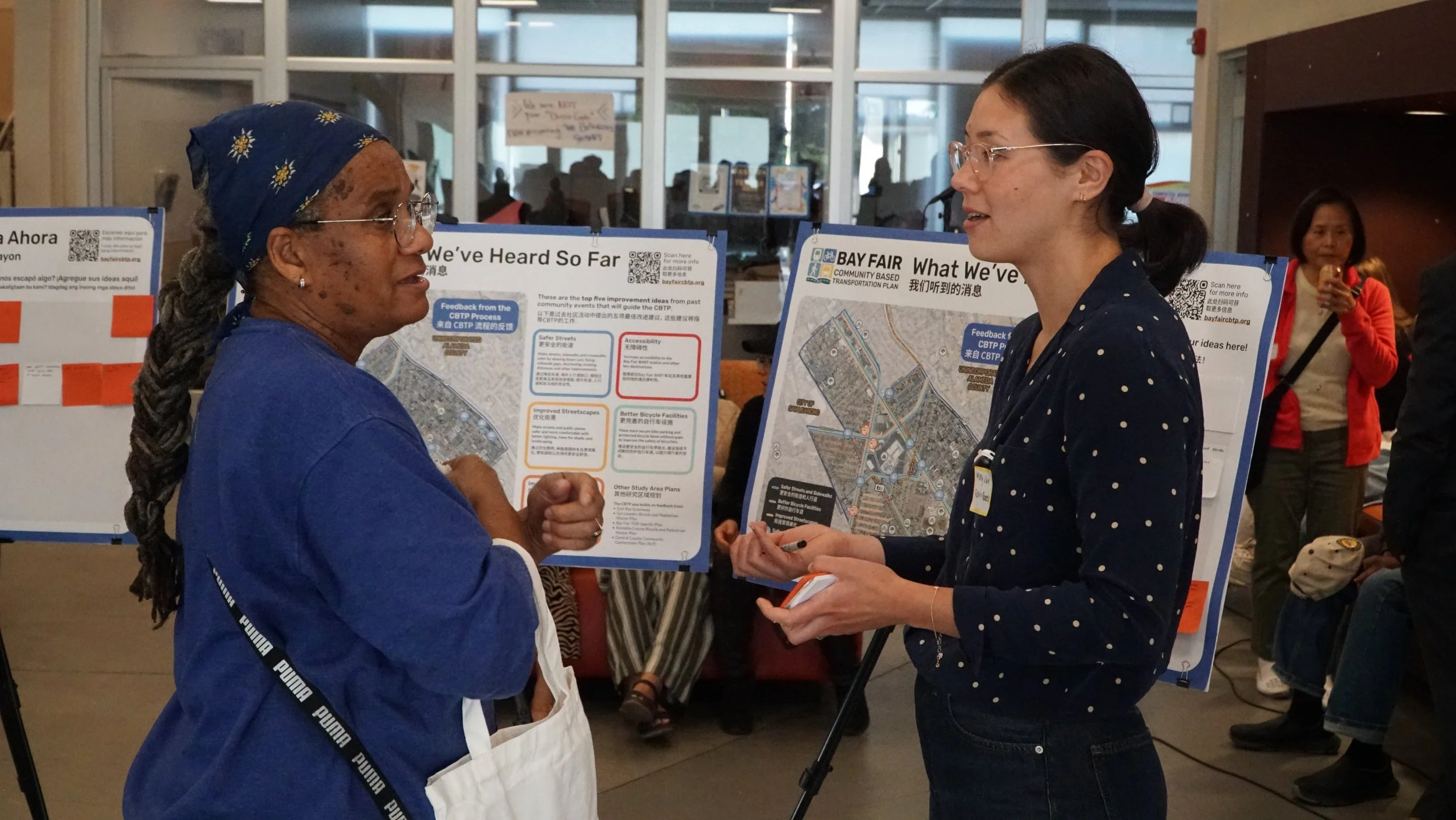 Molly Sun and resident in front of boards - CBTP Open House (2026)