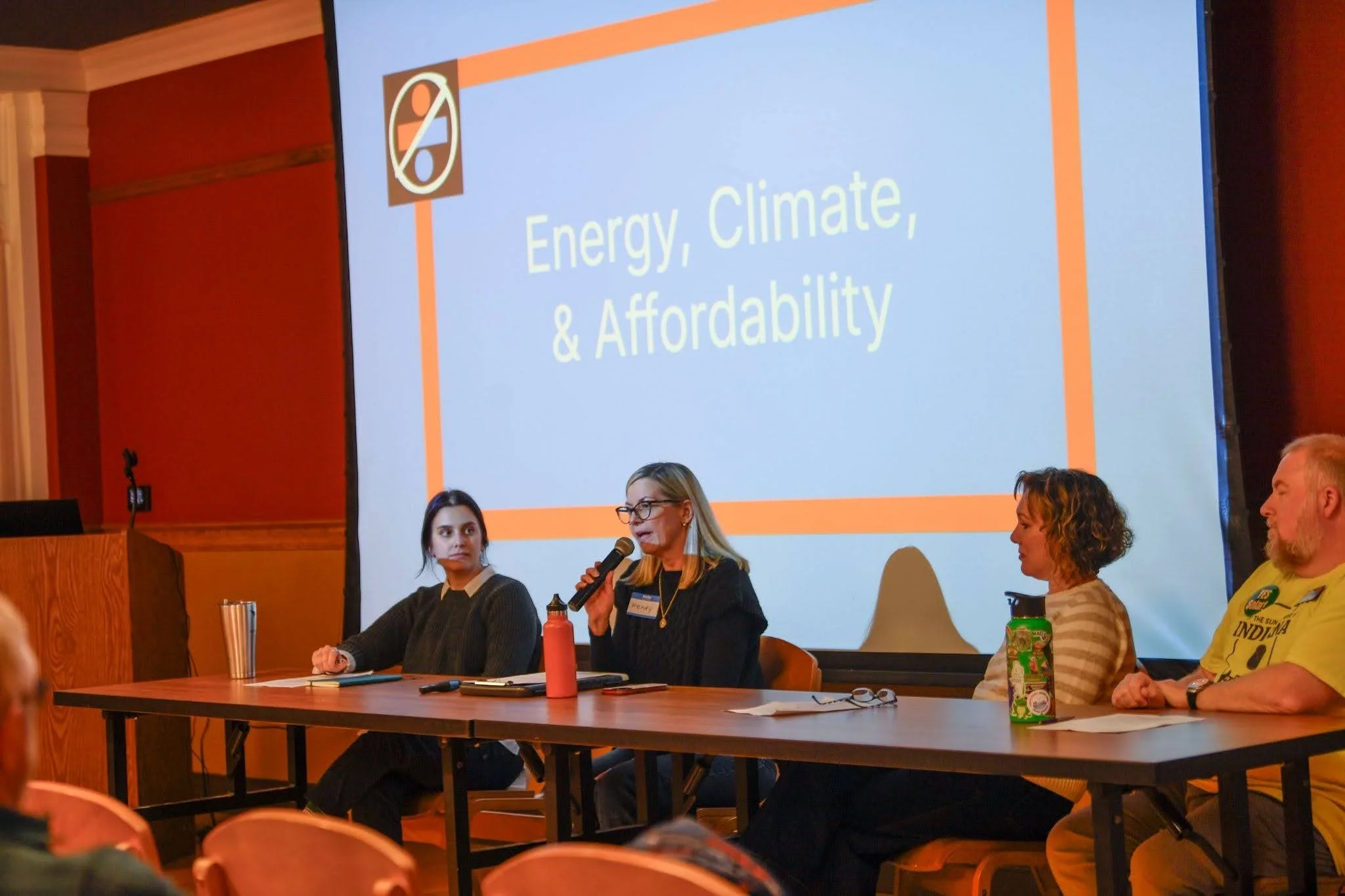 Indivisible Evansville president moderates a panel on energy and affordability at a monthly chapter meeting