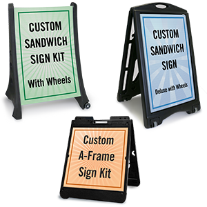 Three portable sandwich sign boards with different colored frames displaying custom sign kits, one green with black text, one black with blue text, and one black with orange text.