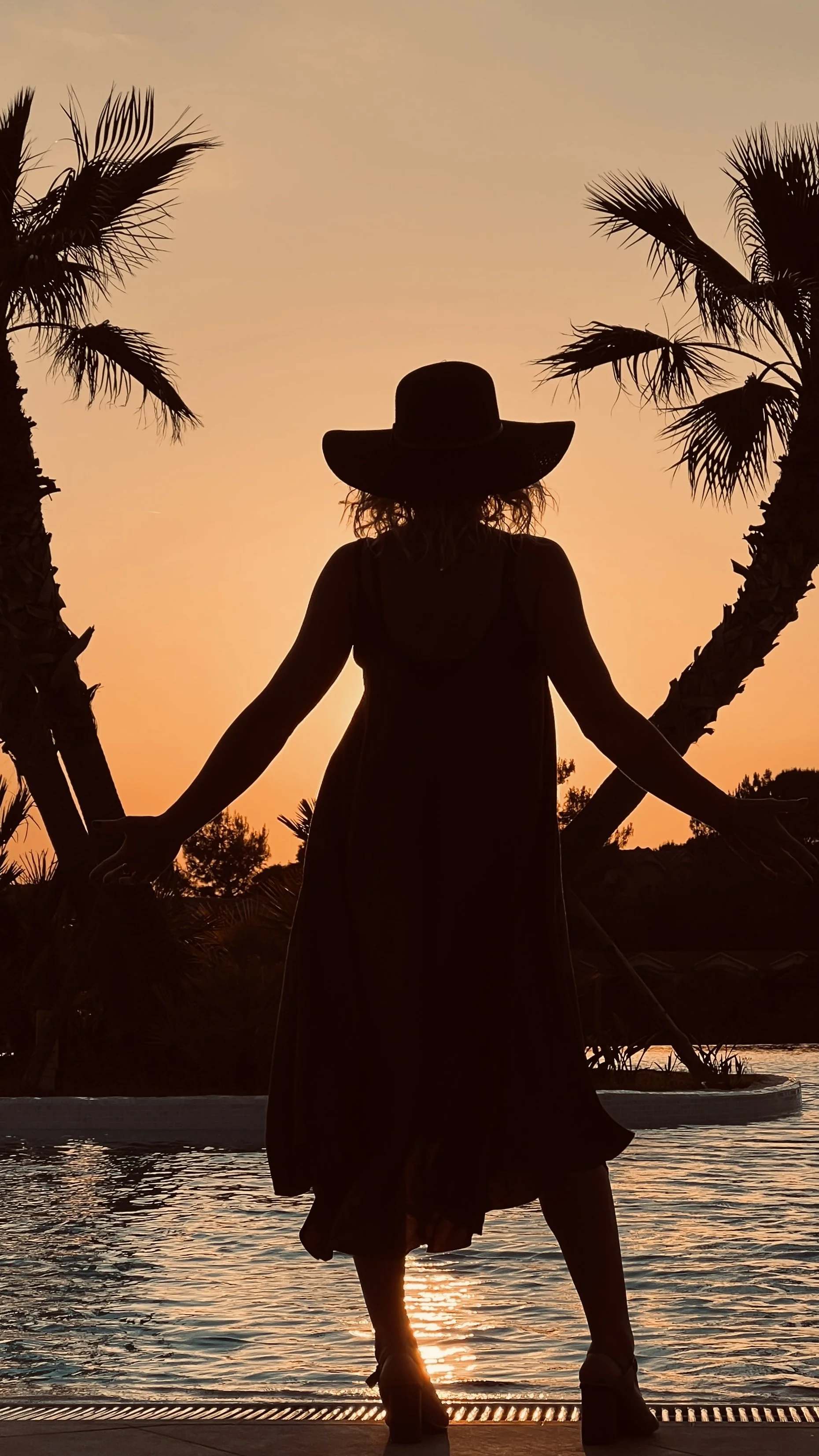Silhouette of woman at sunset during a private luxury travel experience