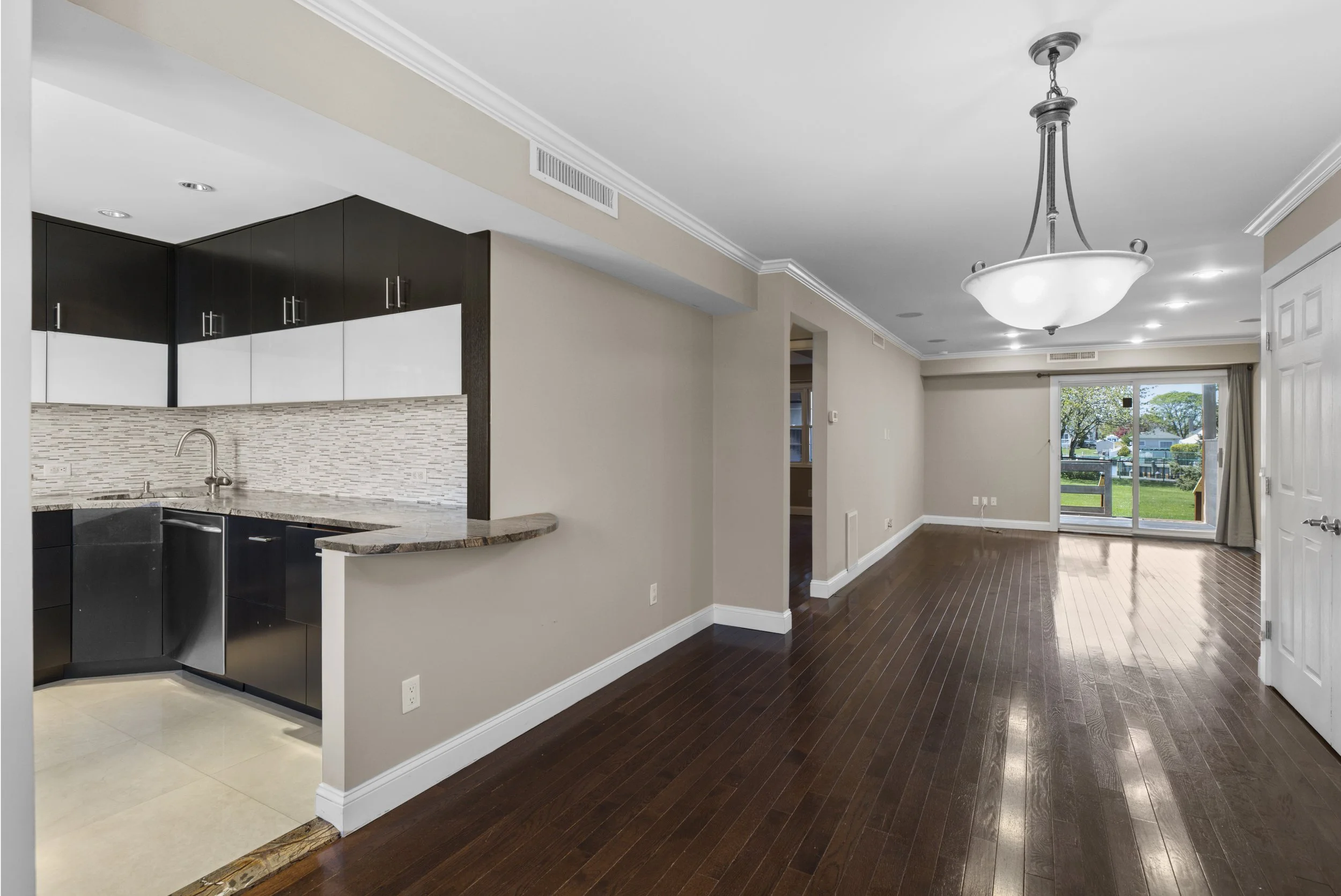Living Room with sliding doors to backyard at  283 Mariners Way, Copiague NY