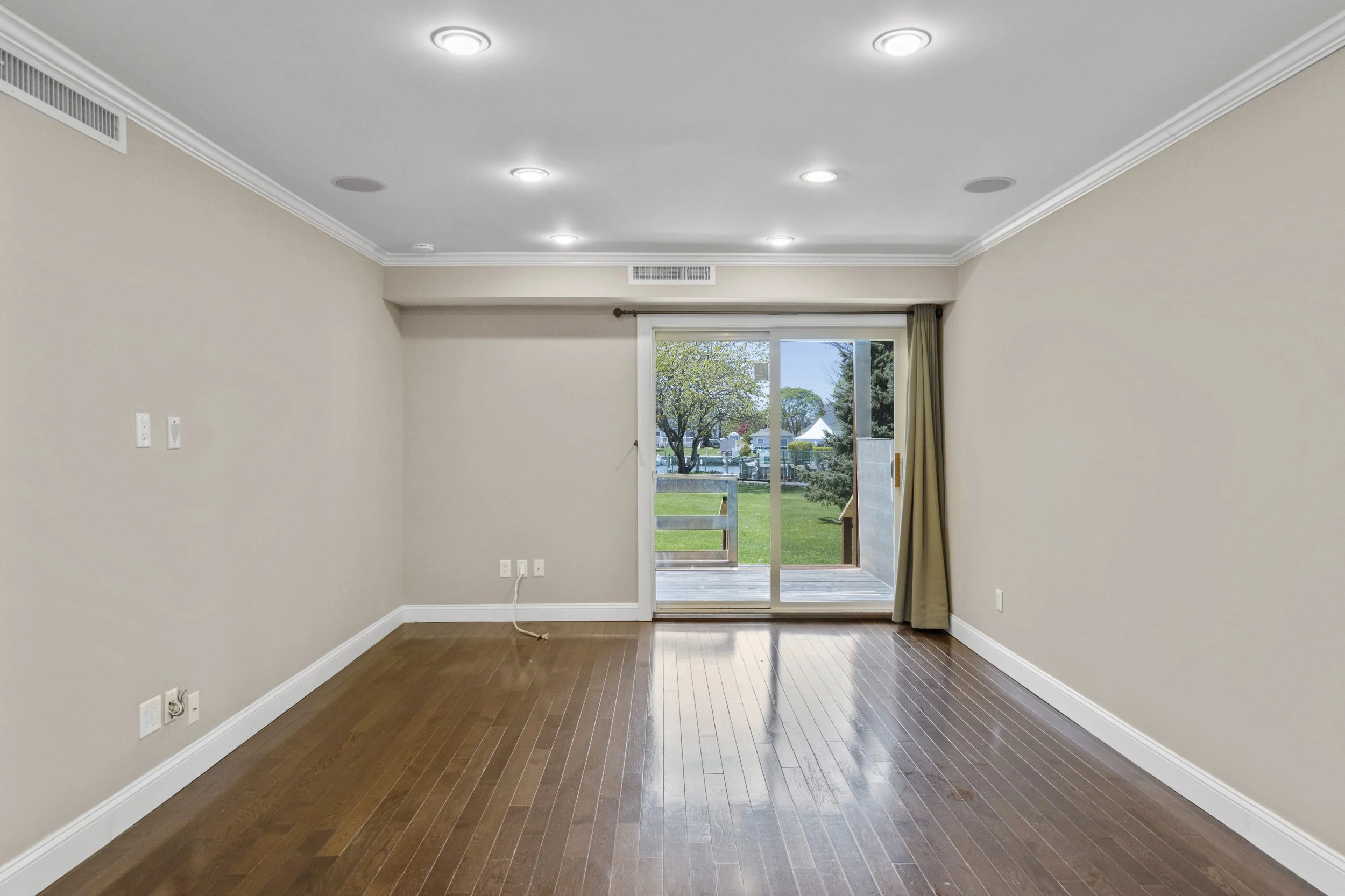 Living Room with Sliding Doors to outside at 283 Mariners Way, Copiague NY