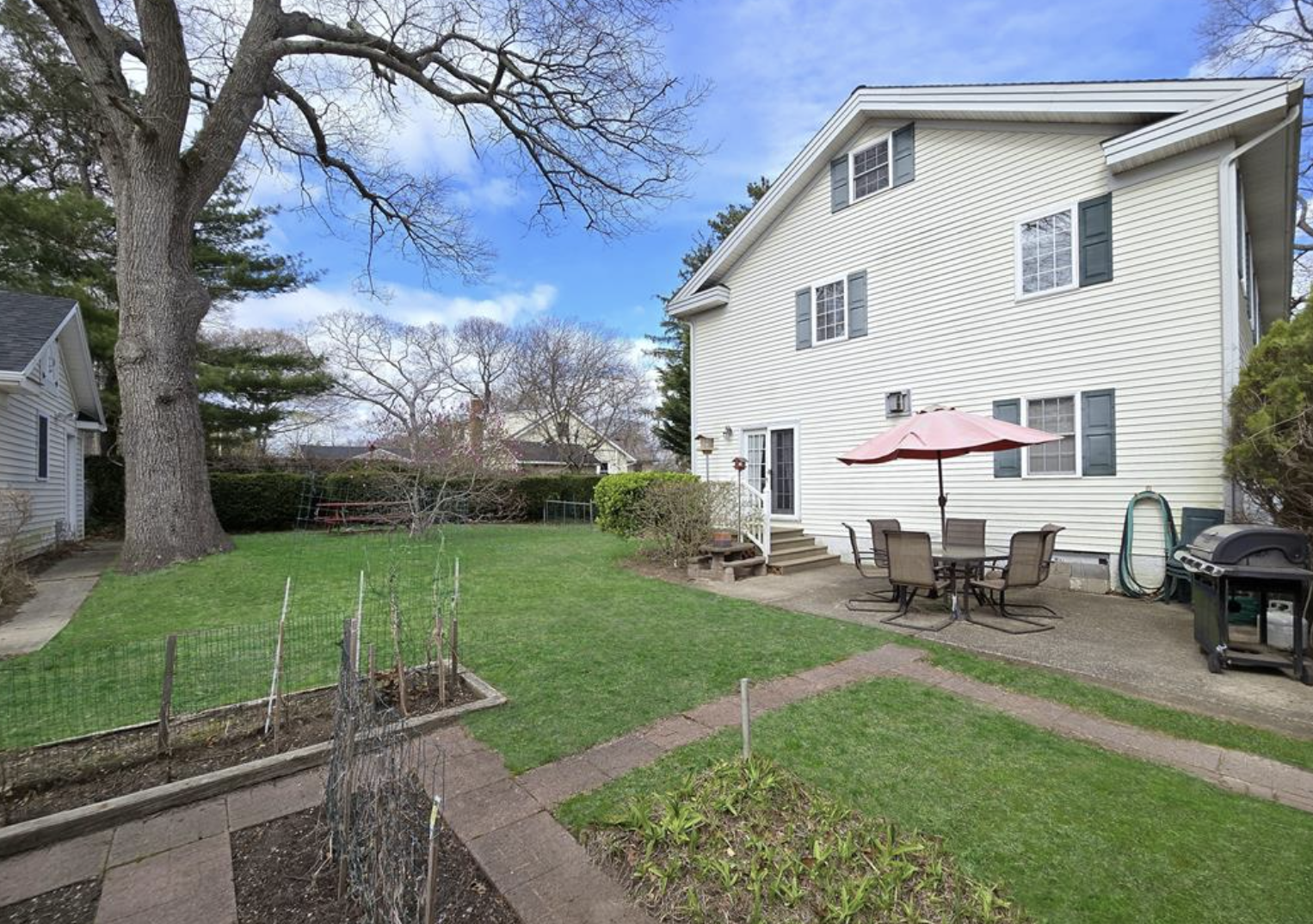 side yard view with paving and large tree, 283 Elizabeth Ave, Holbrook, NY