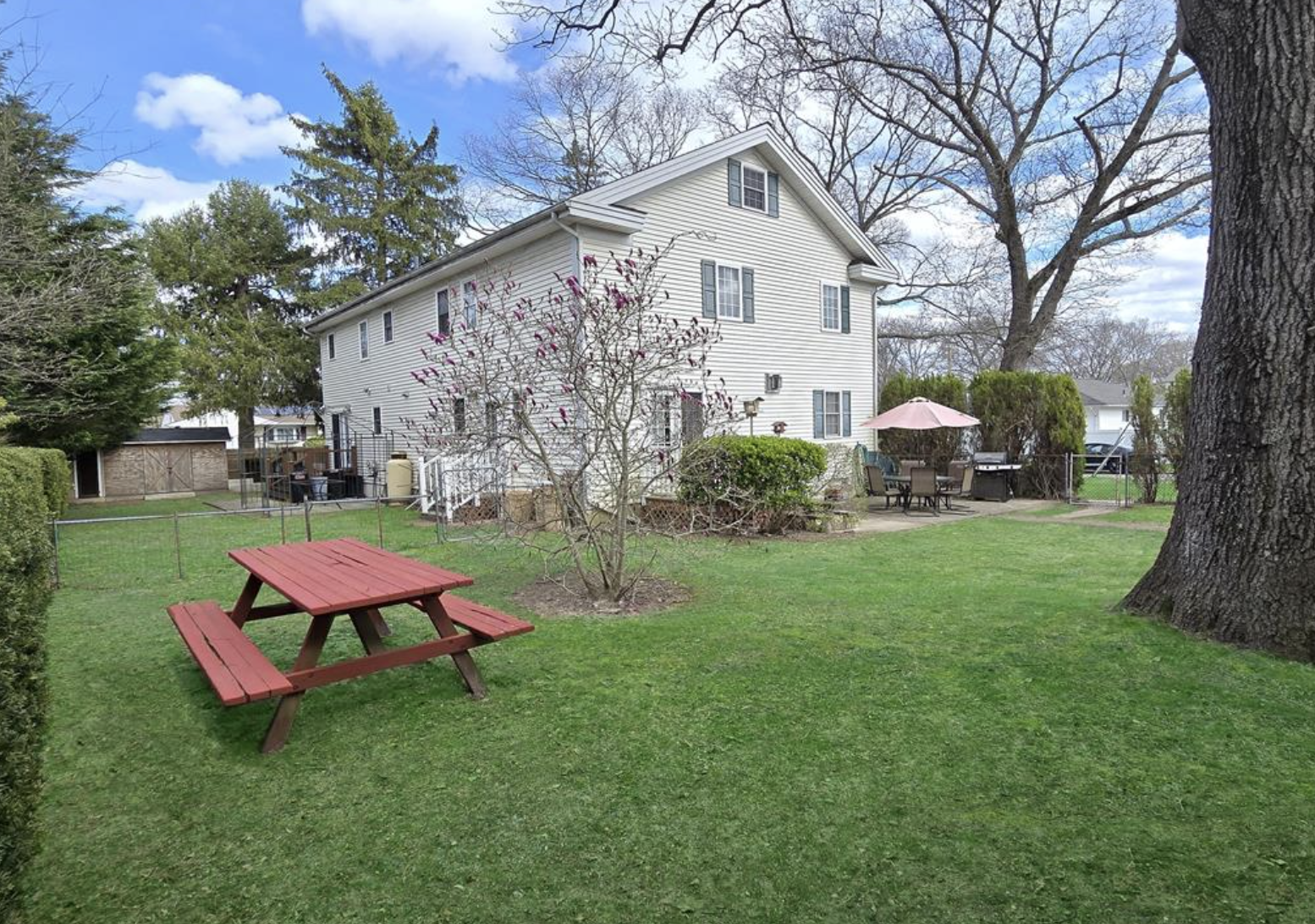 backyard view of home, patio, and shed at 283 Elizabeth Ave, Holbrook, NY