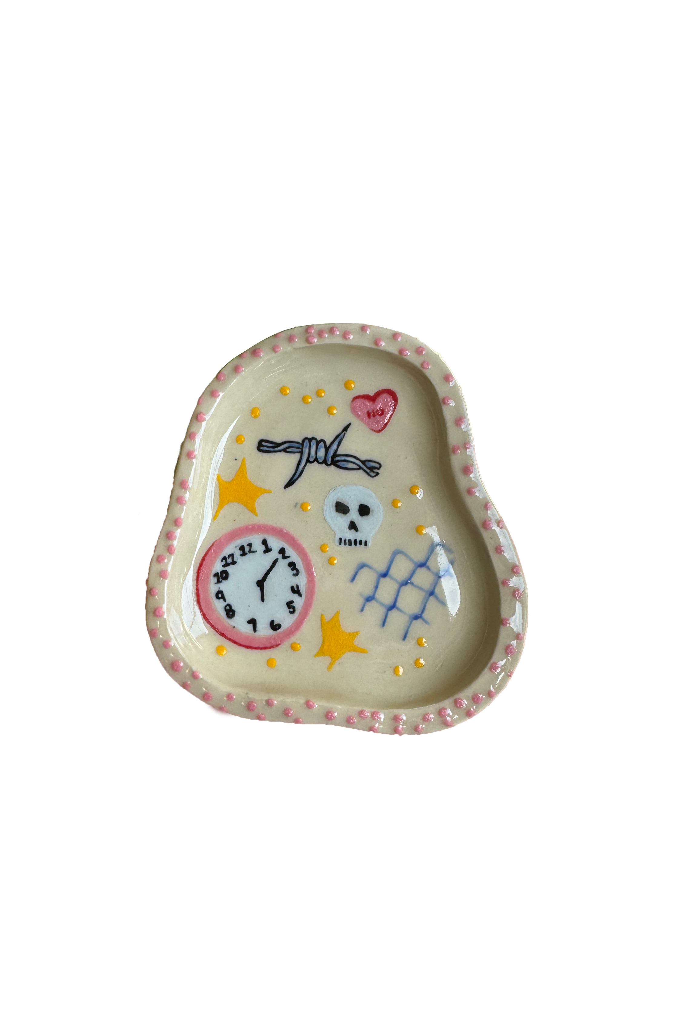 Decorative ceramic tray with painted designs including a skull, clock, hearts, and stars, with pink dotted border.
