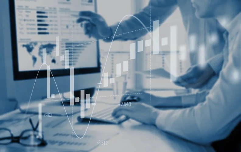 Two people looking at a computer screen