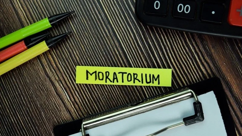 Wood desk with text "Moratorium"