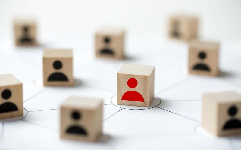 Wooden blocks with black and red user icons
