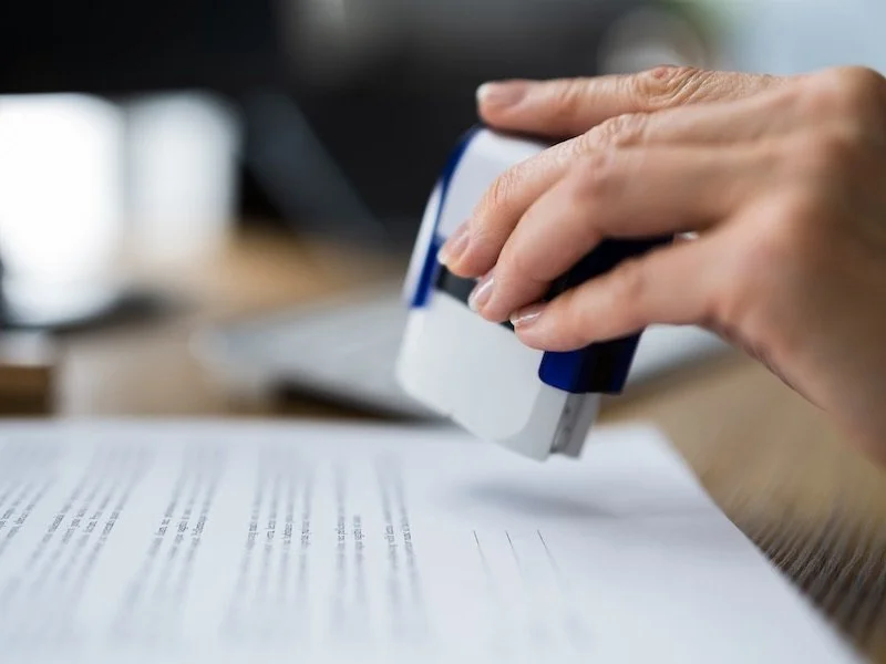 Person stamping a document