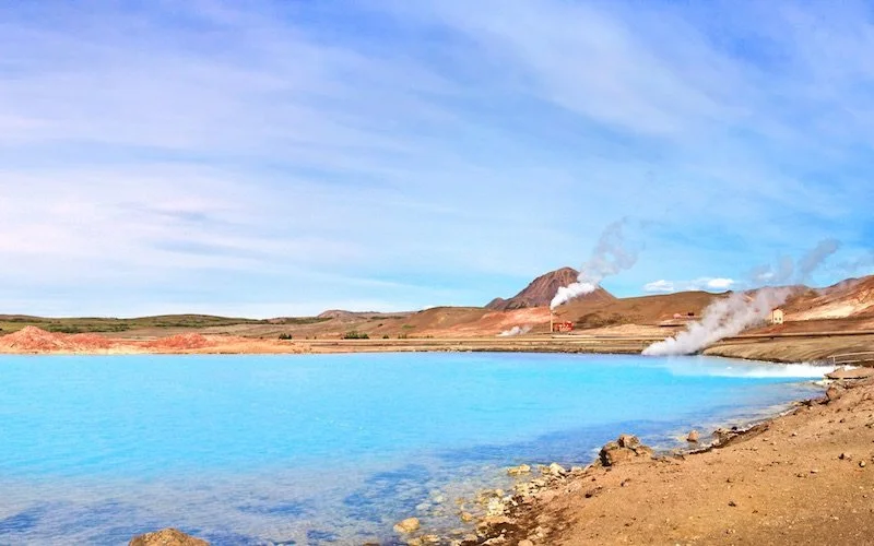 Blue pool of water in front of steam