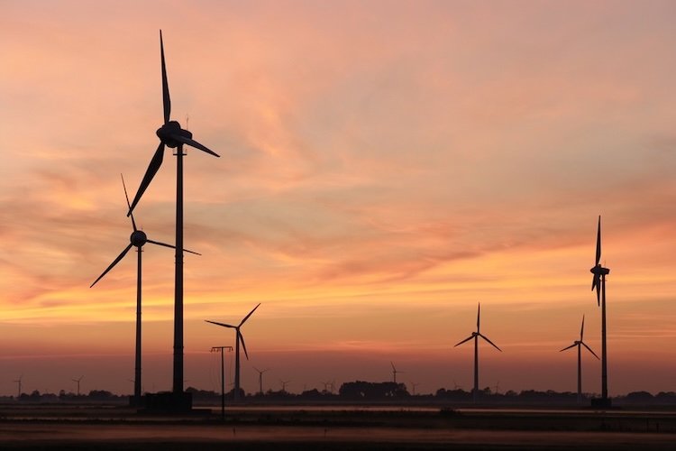 Windmills on a light orange sky
