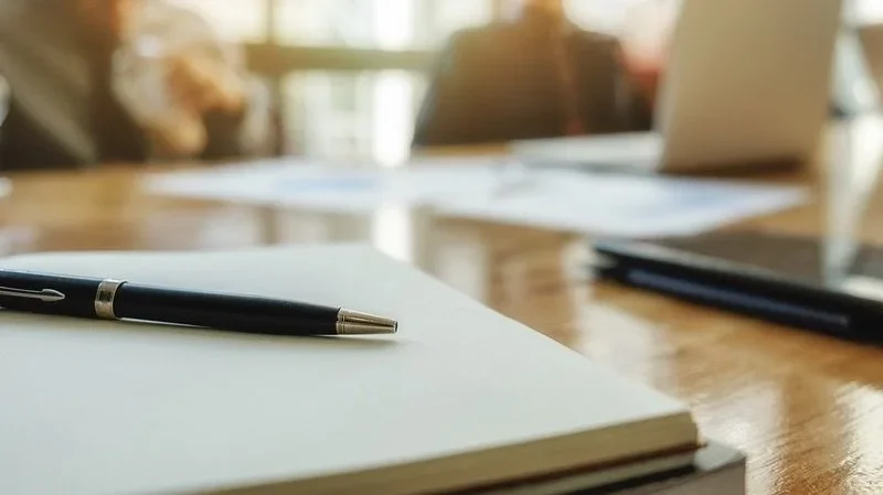 Pen and notepads on desk