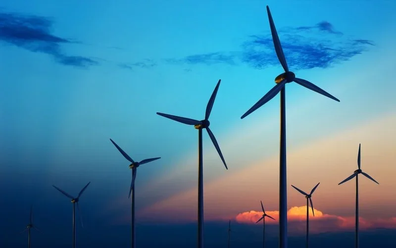 Wind turbines in front of a beautiful sky