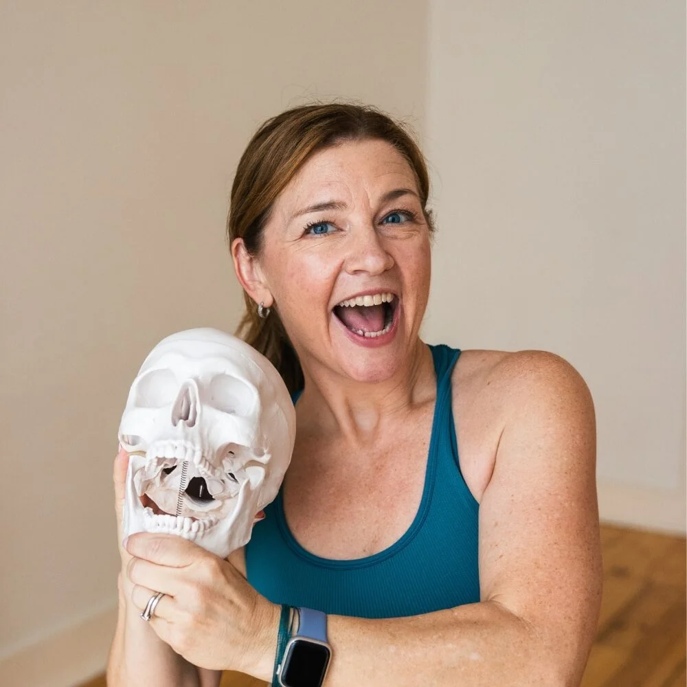 dr trish corley holding skull and smiling