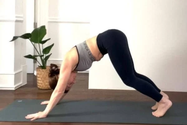 trish in downward facing dog with poor engagement of feet so weight is in her wrists