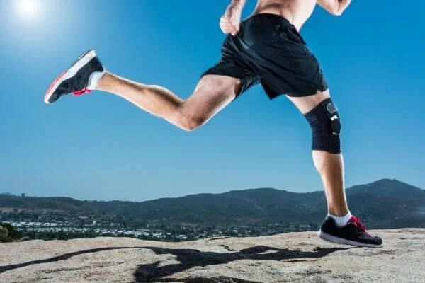 runner-with-knee-brace-how-yoga-helps-with-healing