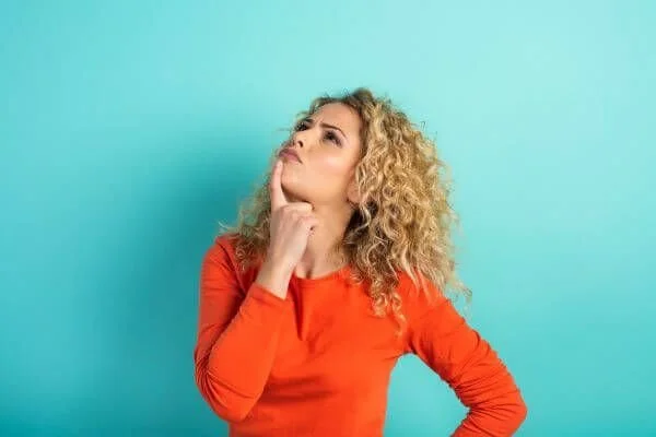 yoga teacher who appears confused with blue background