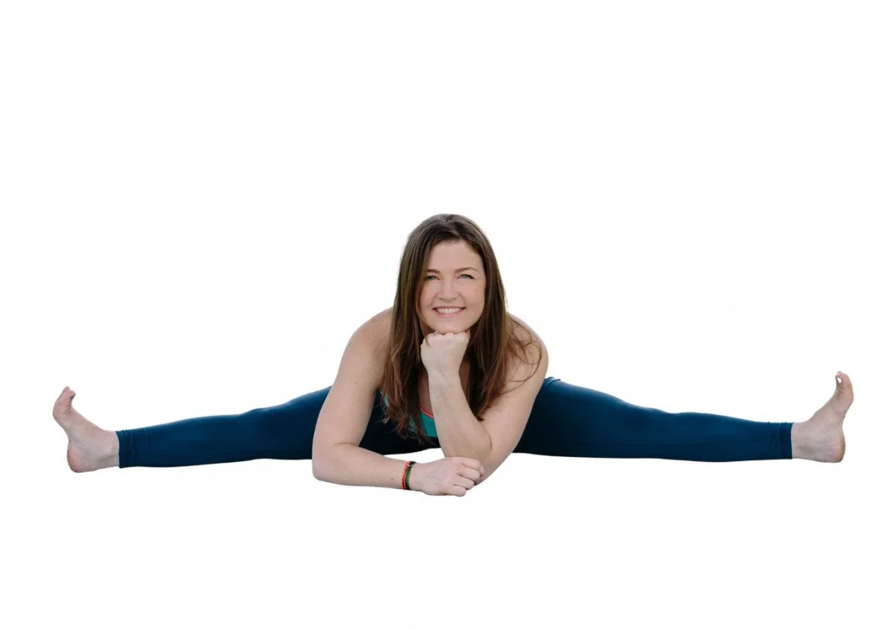 dr trish corley yoga teacher trainer in straddle split with smile