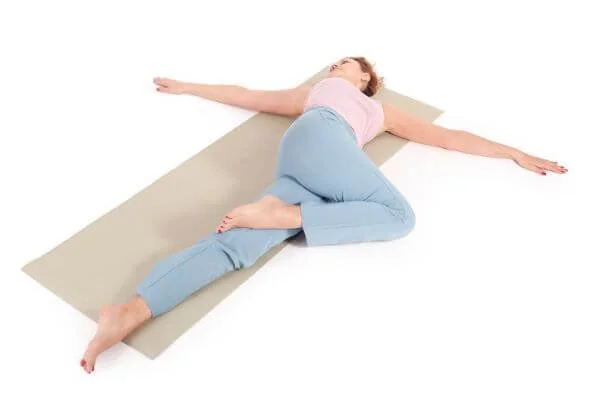 yoga student in supine twist at yoga anatomy school teacher training