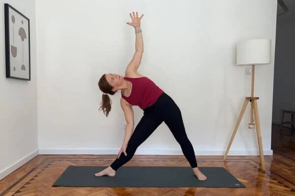 dr trish corley in Triangle yoga posture with a Right Sidebend.