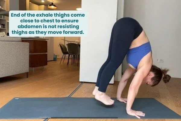 trish corley feet close to hands after floating forward from down dog and at the end of the exhale