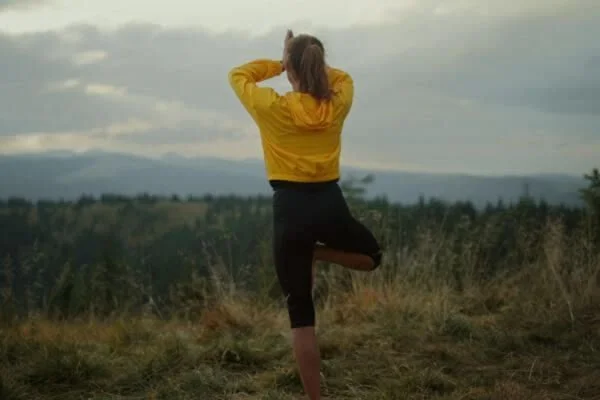 woman on ground in tree pose focused on stability and balance