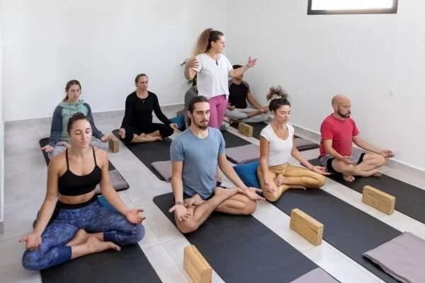 yoga classroom with students on mats and a focused theme