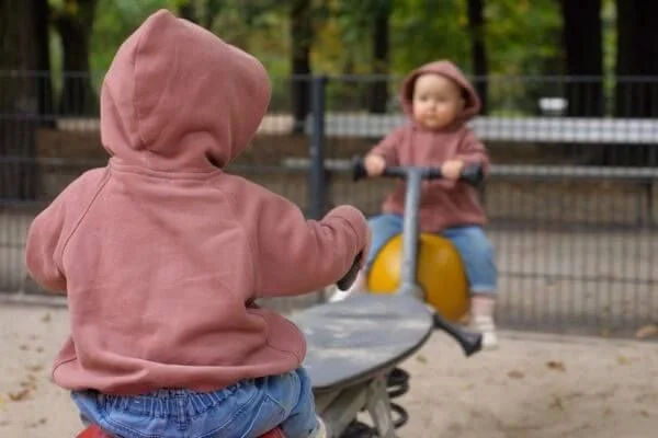 kids on seasaw representing balance needed for crow posture in yoga