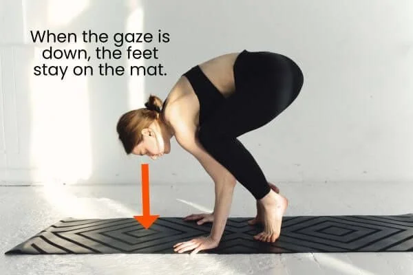 crow posture with gaze down on the mat