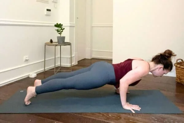 trish corley in chaturanga dandasana on yoga mat with head well aligned