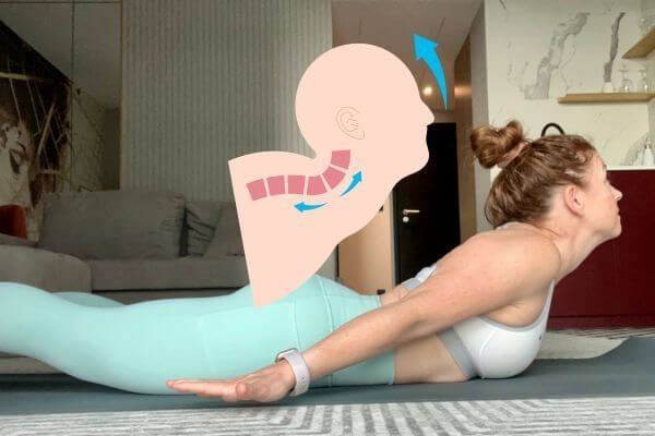 trish corley yoga teacher training demonstrating locust posture and looking up with neck strain