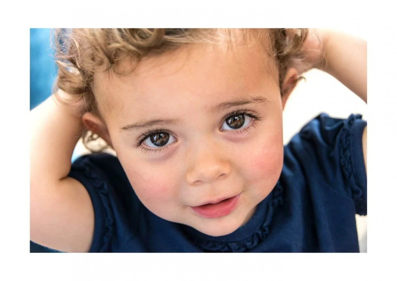 young child with with hands on head able to follow where his bones are