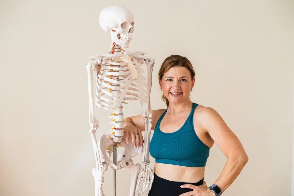Dr. Trish Corley with anatomy skeleton at Yoga Anatomy School