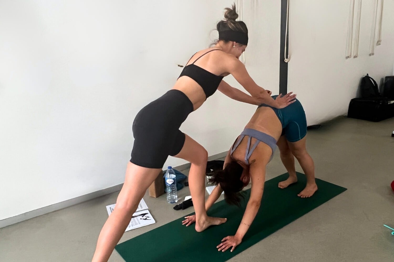 : Sarah Kelly practicing hands on assists during Power to Lead yoga teacher training in Lisbon Portugal