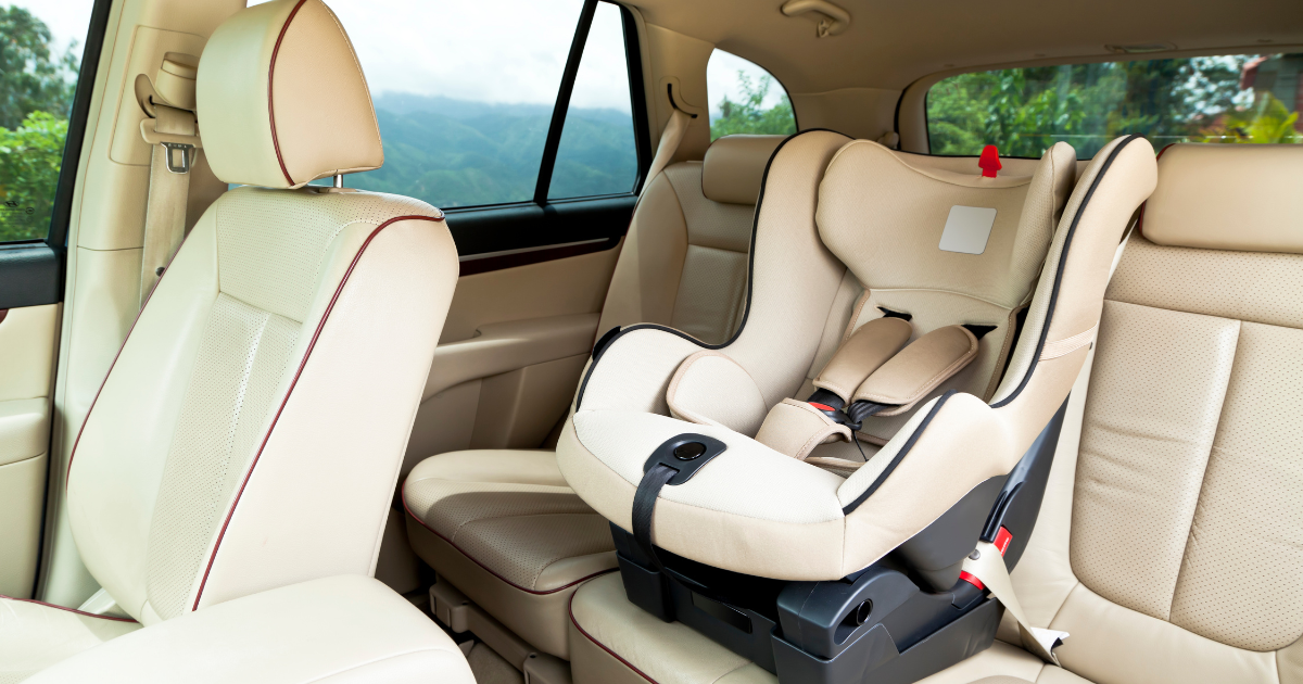 Interior of a car showing two passenger seats, one of which is a child car seat.