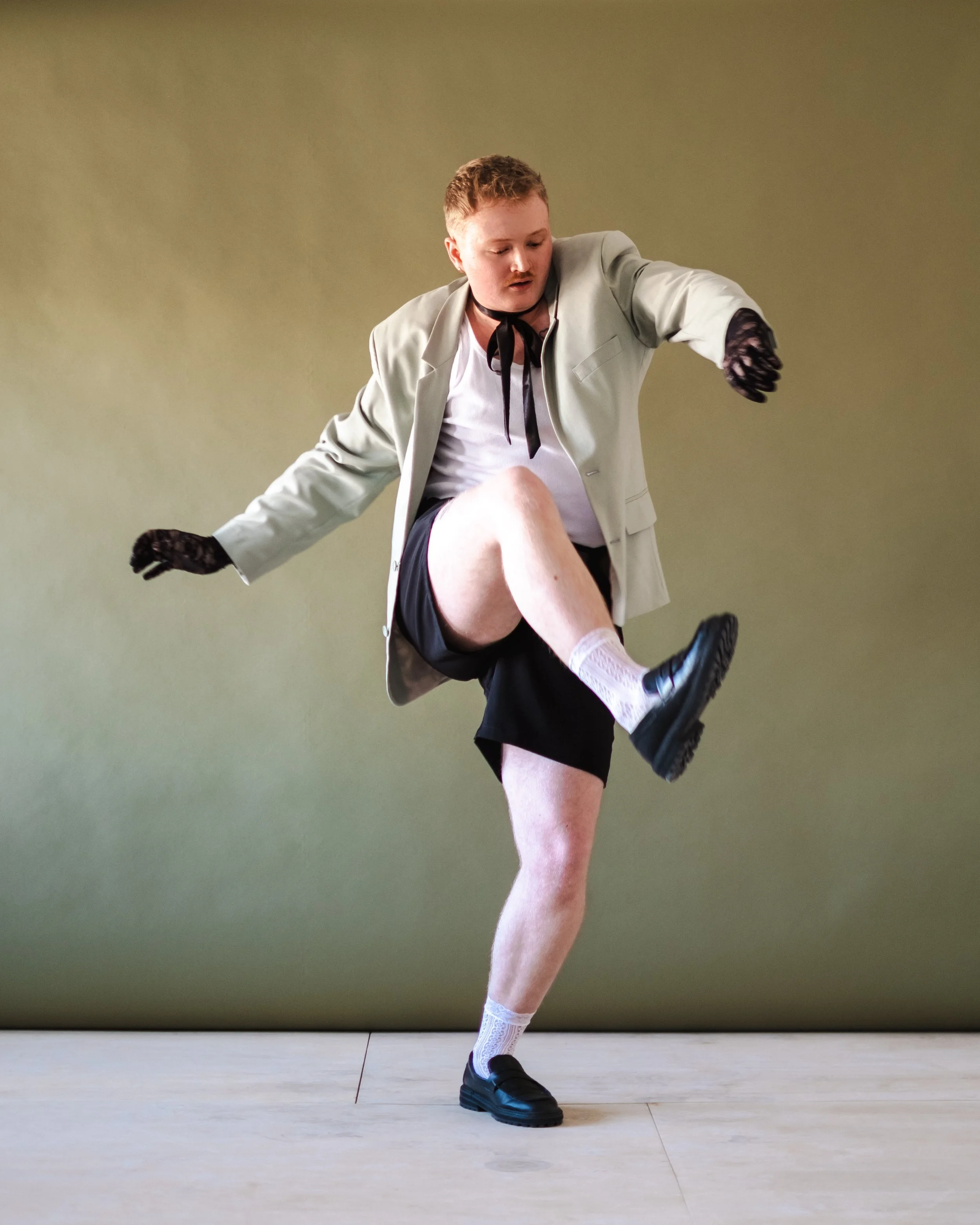 Artistic director, Logan Hathaway, dancing against a plain background.