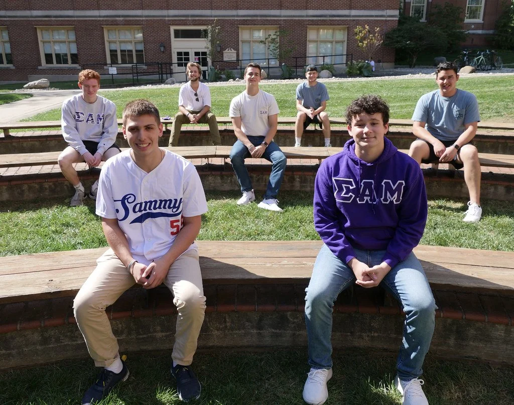 Undergraduates on campus benches