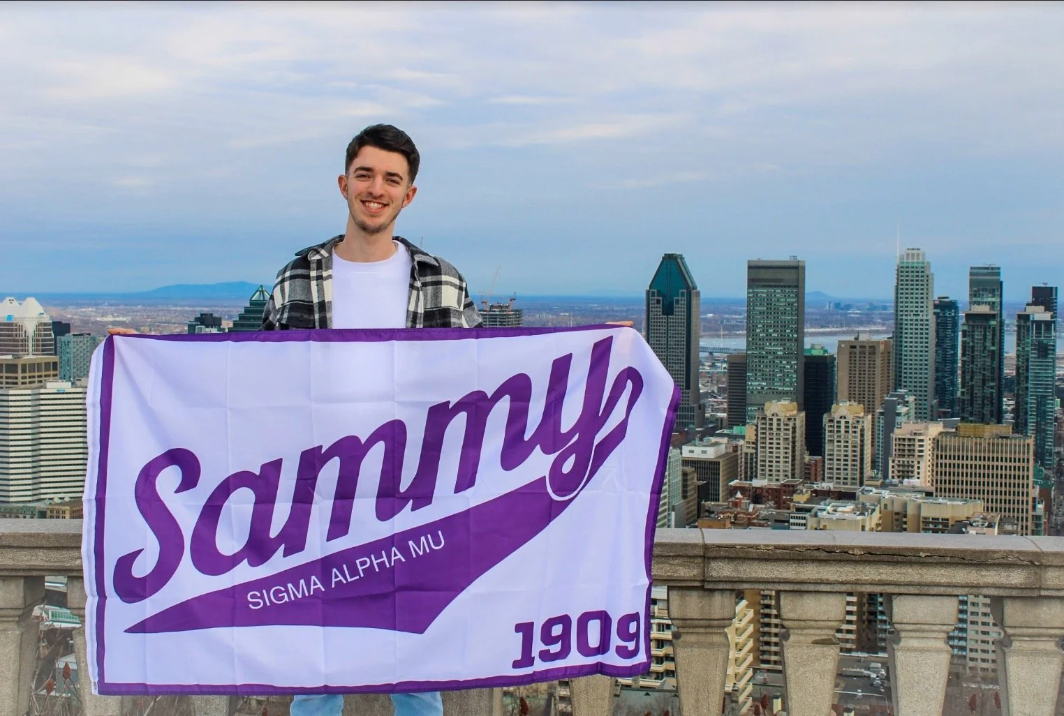 Undergraduate holding Sammy flag