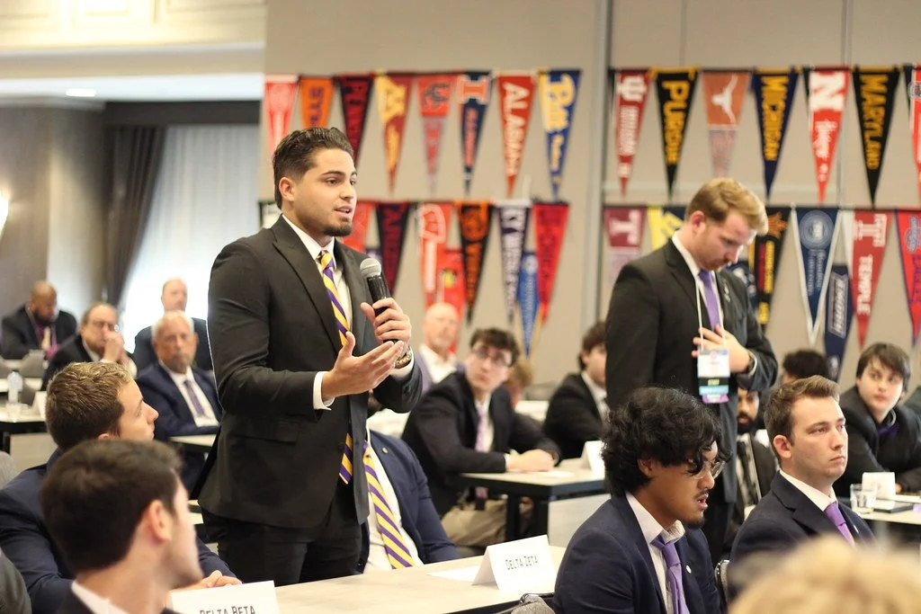Two undergraduates speaking at conference.