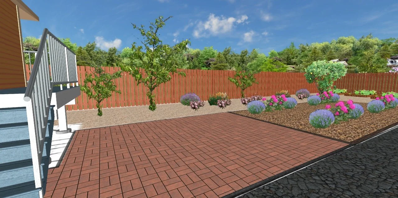 A backyard with a brick patio, a garden bed with colorful plants, small trees, and a wooden fence under a blue sky with some clouds.