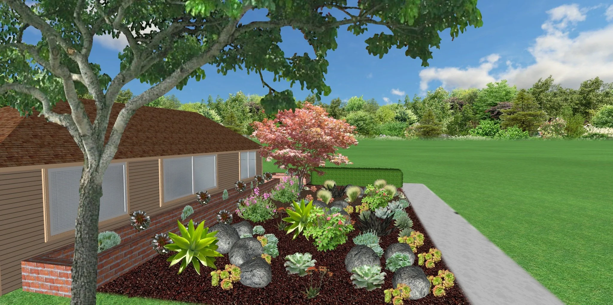A landscaped garden with various colorful plants, rocks, a pink flowering tree, and a large tree in the foreground, adjacent to a house with a brown shingle roof and a brick and siding exterior, next to a concrete walkway on a sunny day.