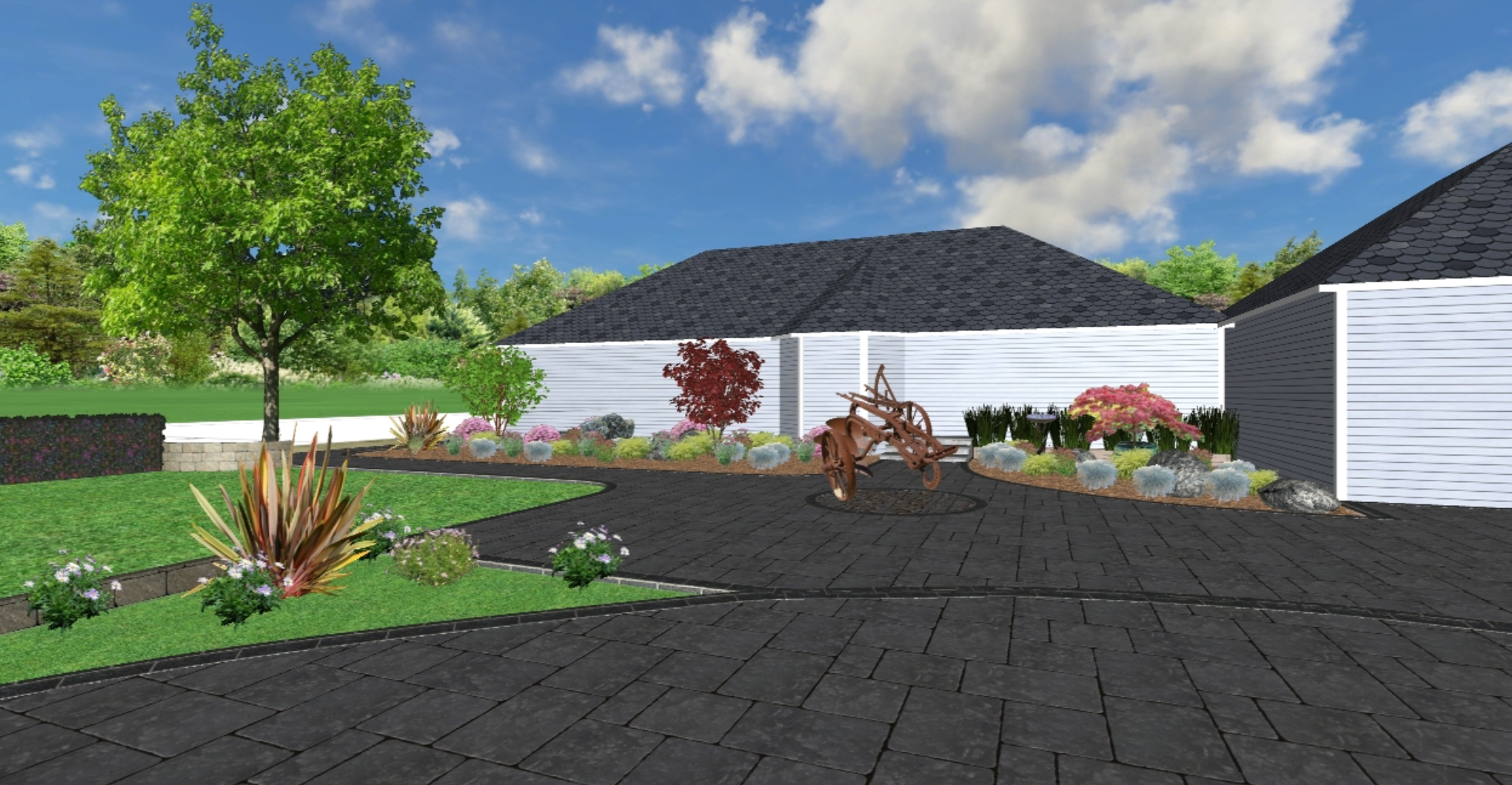 A landscaped backyard with a large tree, various plants, flower beds, a curved dark stone patio, and a white fence. There is a rust-colored sculpture of farming equipment and a house with dark roofing.