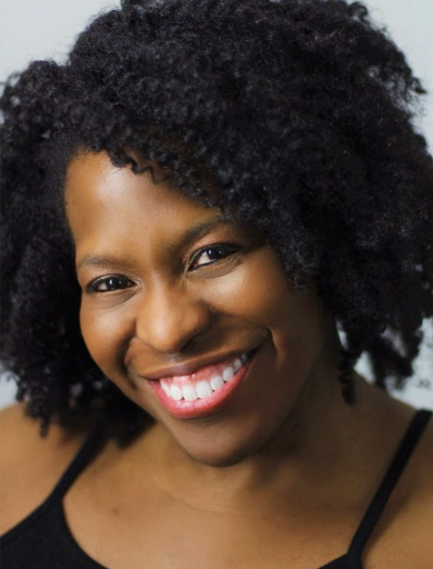 Close-up of a smiling African American woman with natural curly hair wearing a black tank top.