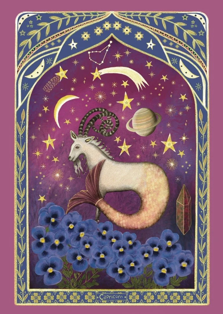 A mystical illustration of a Capricorn zodiac sign. It features a hybrid creature with the upper body of a goat with curved horns and the tail of a fish, surrounded by blue flowers at the bottom. The background depicts a night sky with stars, moons, planets, and celestial patterns. The border is decorated with stars, leaves, and floral designs, with a label reading 'Capricorn' at the bottom.