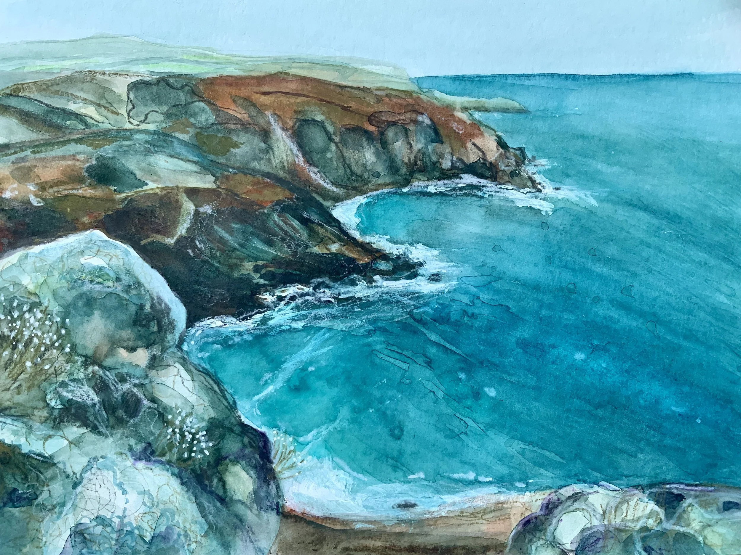 Watercolour painting of rocky coastline with ocean waves, green hills in the background, and a sandy beach in the foreground.