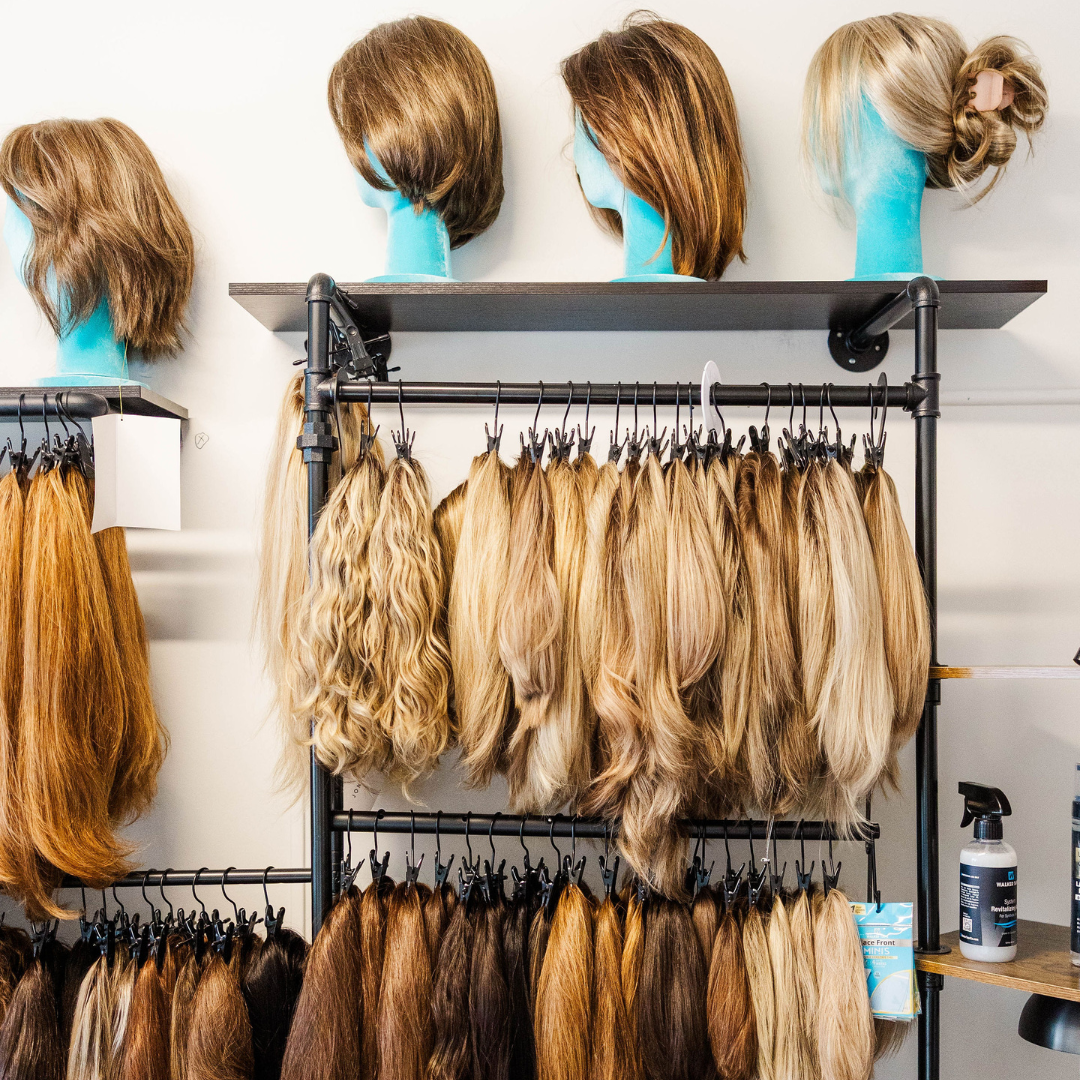 Here is an image of the bLUXE private wig room and wig stock in all hair colors and textures with our signature teal blue heads
