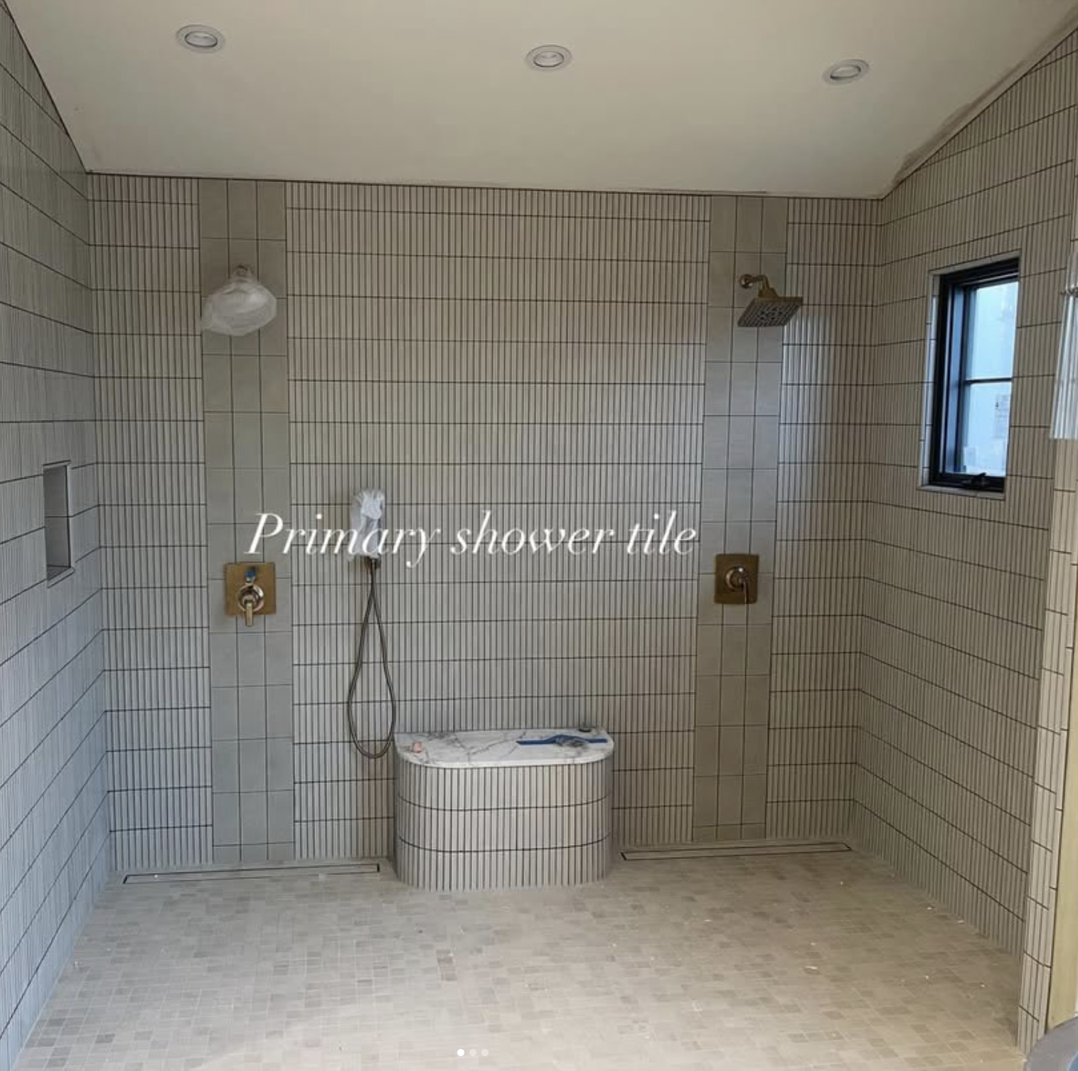 Bare bathroom with tile shower walls, a window, and fixtures for a shower and bathtub, labeled 'Primary shower tile'.